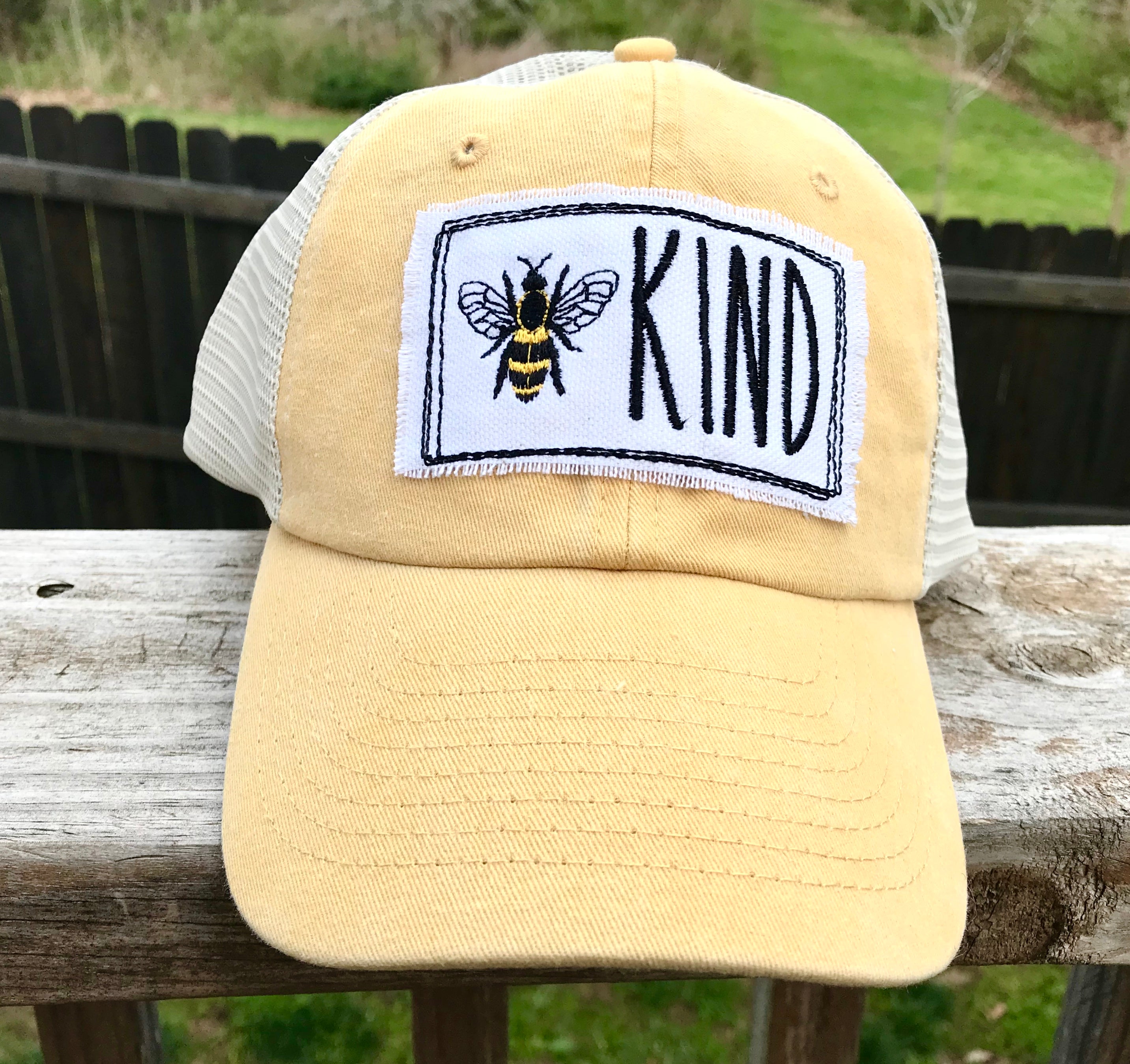 Bee Kind mustard pigment dyed trucker cap