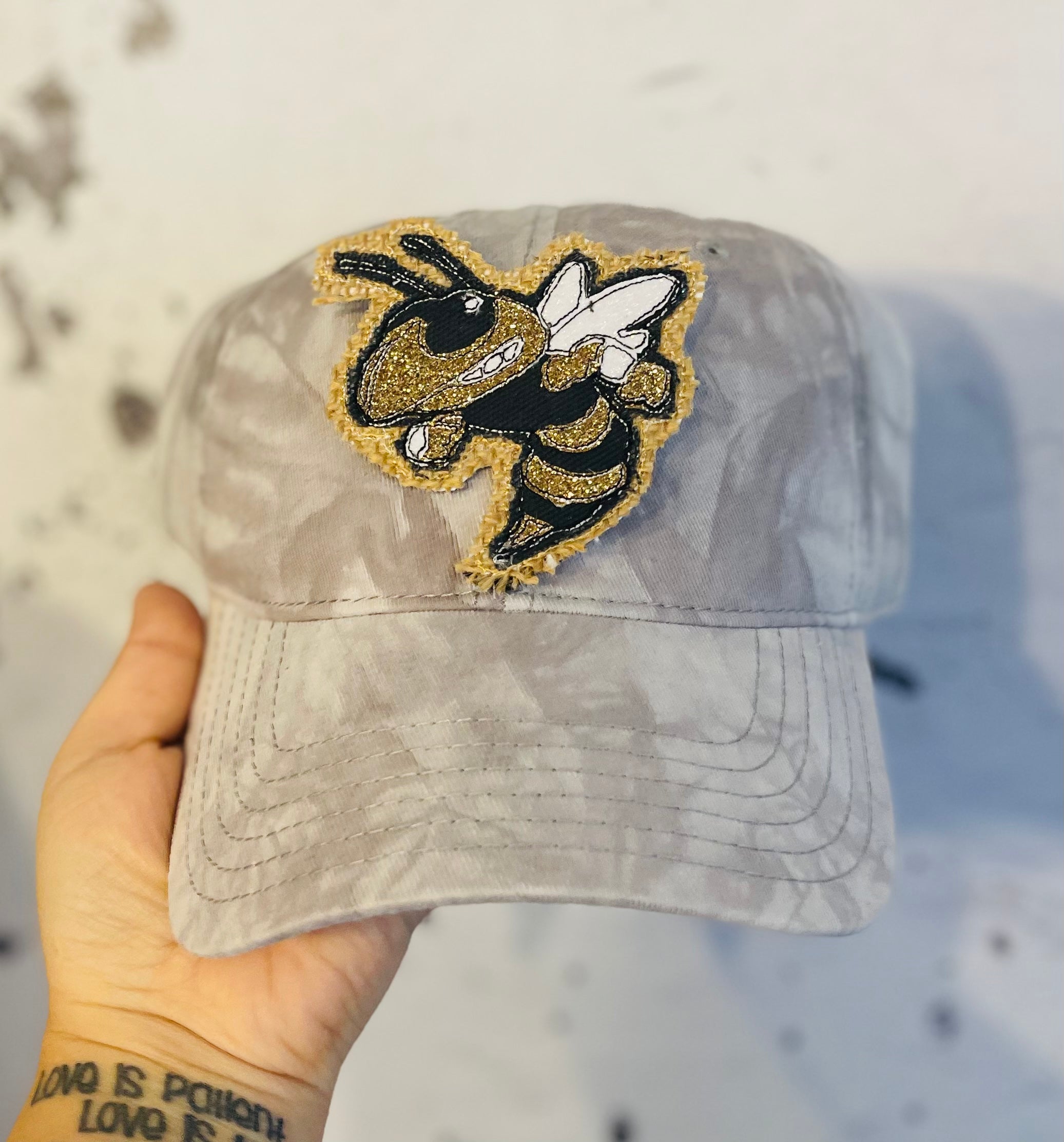 Buzz patch on distressed baseball cap ponytail