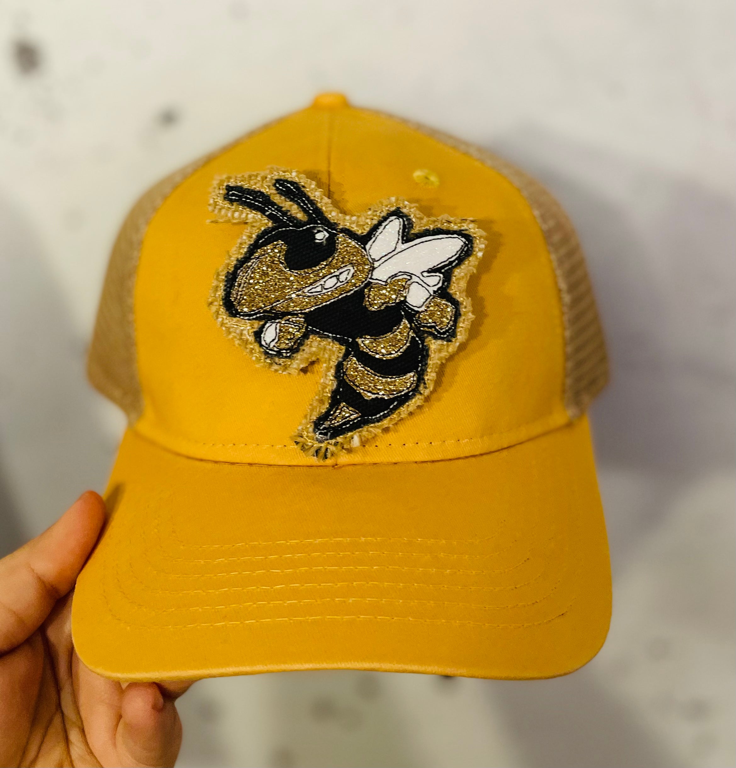 Buzz patch on distressed baseball cap ponytail