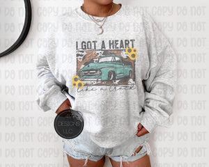 I got a heart like a truck unisex Ash crewneck sweatshirt