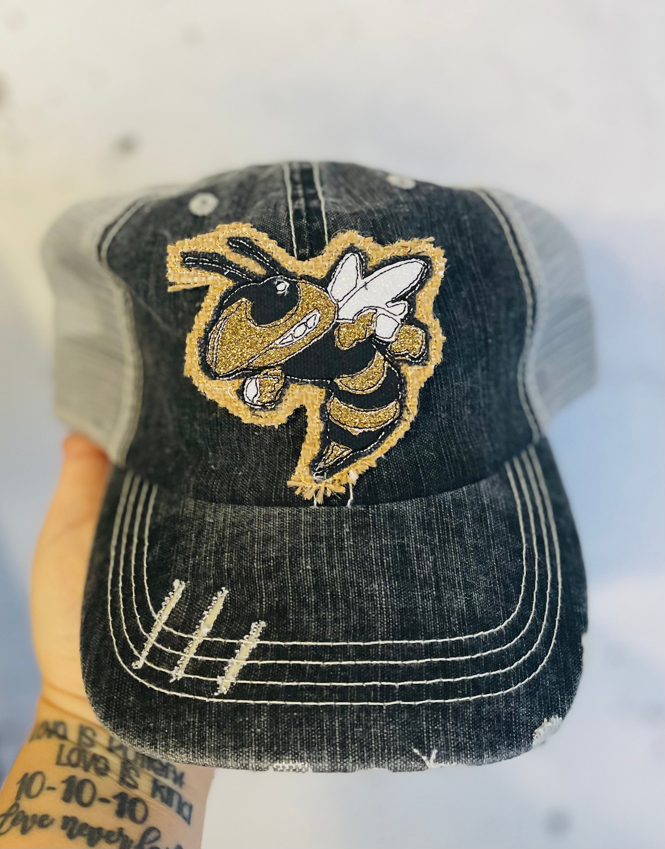 Buzz patch on distressed baseball cap ponytail